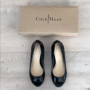 Black patent leather Cole Haan peep toe wedges